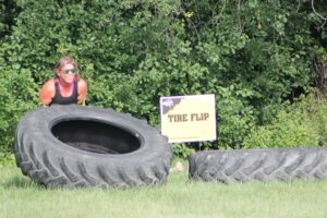 photo of participant lifting tire at the 2025 H-F Beast Obstacle Course Dash