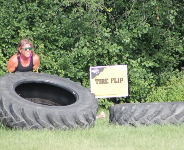 photo of participant lifting tire at the 2025 H-F Beast Obstacle Course Dash
