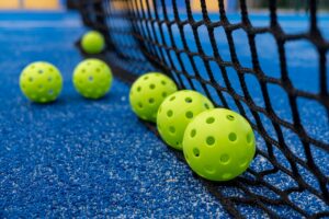 photo of pickleballs next to a net