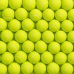 photo of a wall of tennis balls