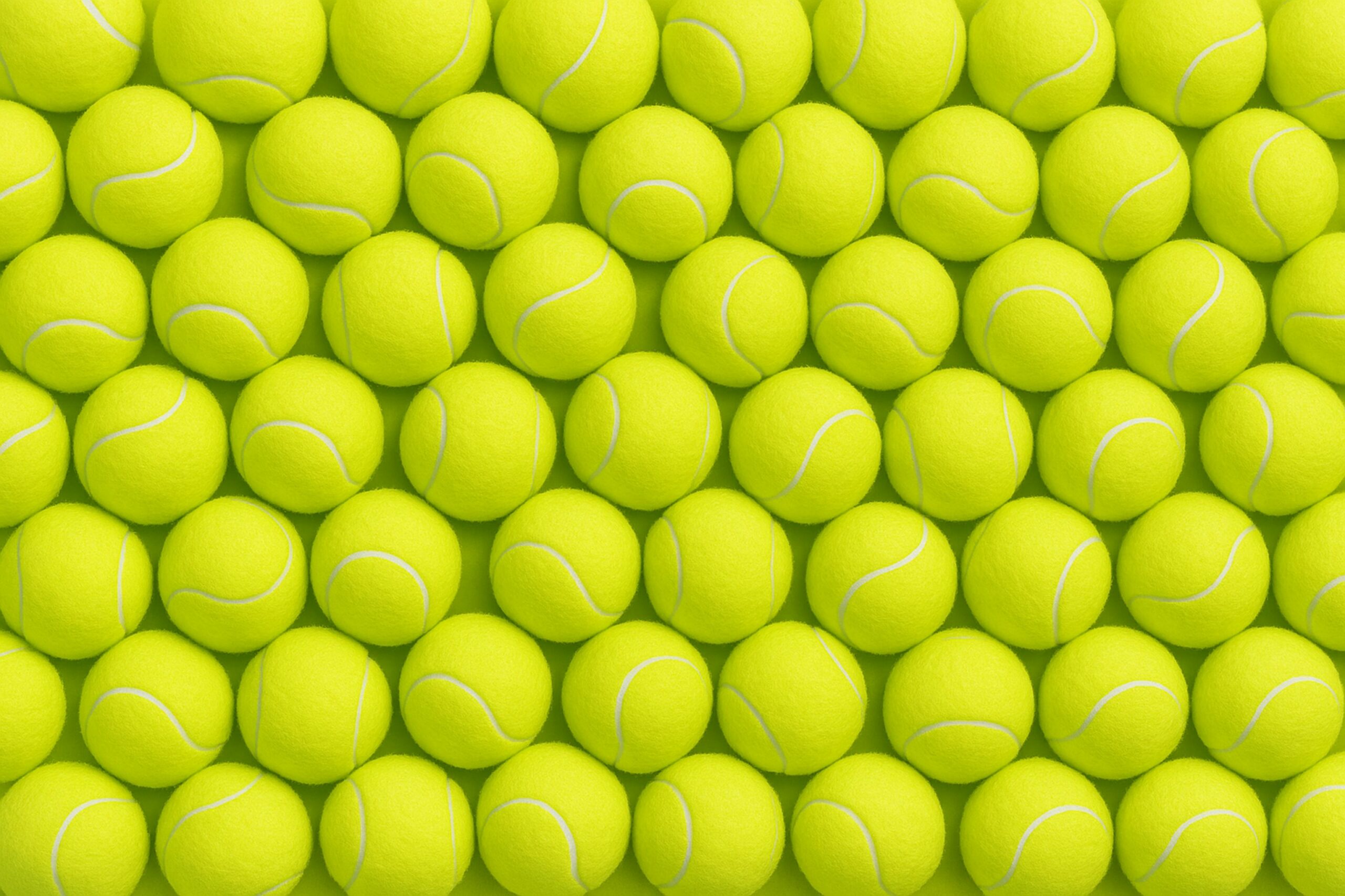 photo of a wall of tennis balls