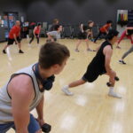 photo of a group fitness class where participants and using free wights